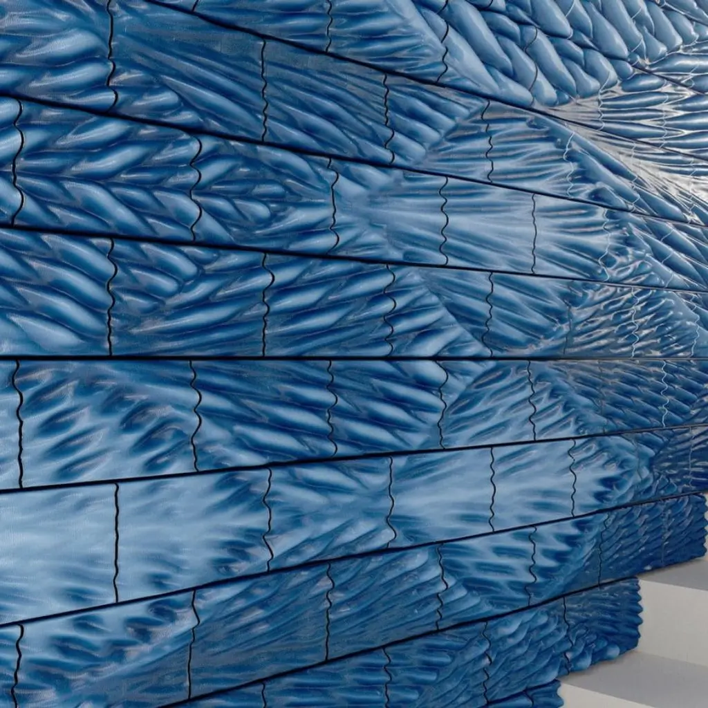 Textured wall with blue 3D wave patterns created via advanced ceramic tile printing.