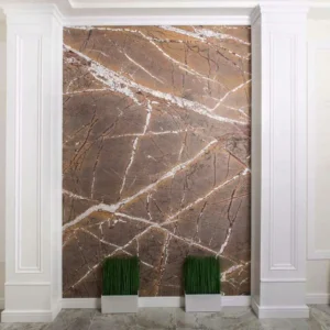 A contractor fitting lightweight faux stone cladding onto the exterior foundation of a new home.