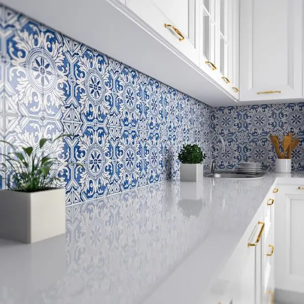 Elegant kitchen interior design Dubai with blue patterned tiles and white cabinetry